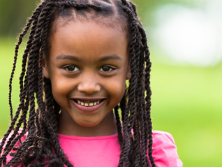 Outdoor close up portrait of a cute young black girl - African p